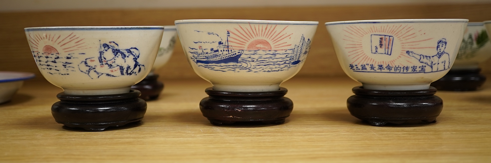 A Chinese Cultural Revolution porcelain teapot, six bowls, wood stands and an enamel tray-29.5cm diameter. (8)
